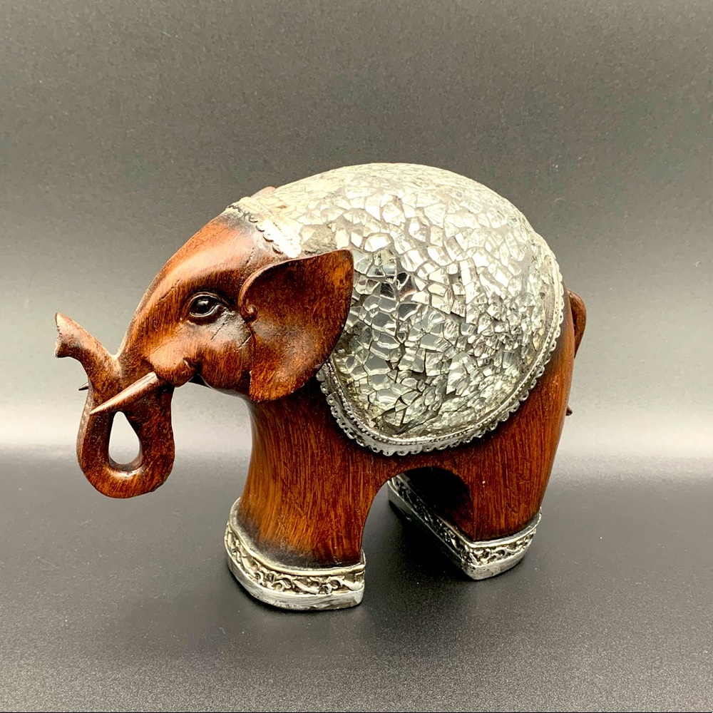 Carves wooden elephant